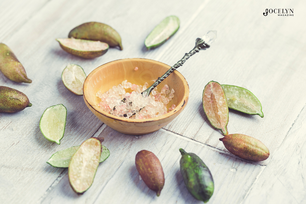 Finger Limes - pulp in a dish and fruits around it.