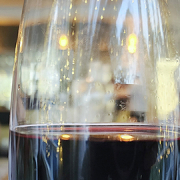 A taste of Italy - a glass of red wine and people wine tasting