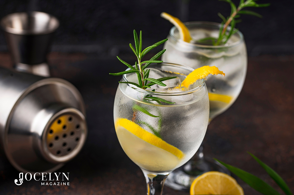 Gin Infusions - cocktail shaker lying down and two glasses of gin and botanicals