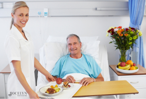 Cooking for Recovery - Hospital staff serving a man food.