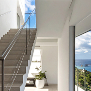 Architectural interior staircase with ocean views in a coastal Mater Lotteries prize home