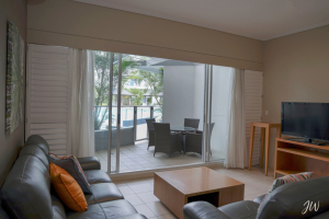 Oaks Hervey Bay staycation: Sliding doors open to a private terrace at Oaks Hervey Bay, where indoor comfort meets poolside calm.