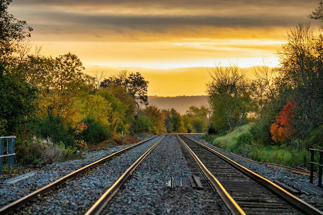 Rail Travel in Australia and New Zealand - train tracks at unrise or sunset