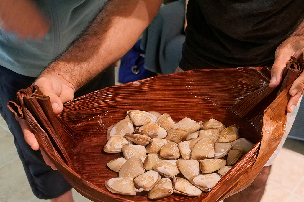 Fraser Coast arts: Traditional woven palm frond basket holding eugaries gathered on K’gari (Fraser Island), part of Butchulla cultural food traditions on the Fraser Coast.