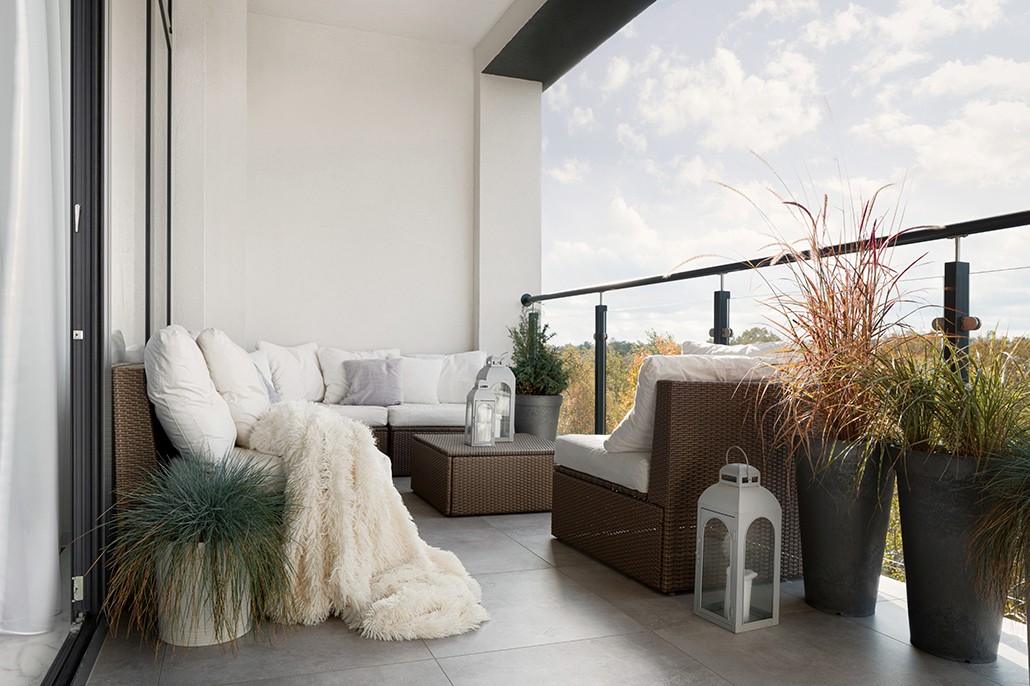 Townhouse living: Cosy apartment balcony with outdoor seating and plants in a modern townhouse