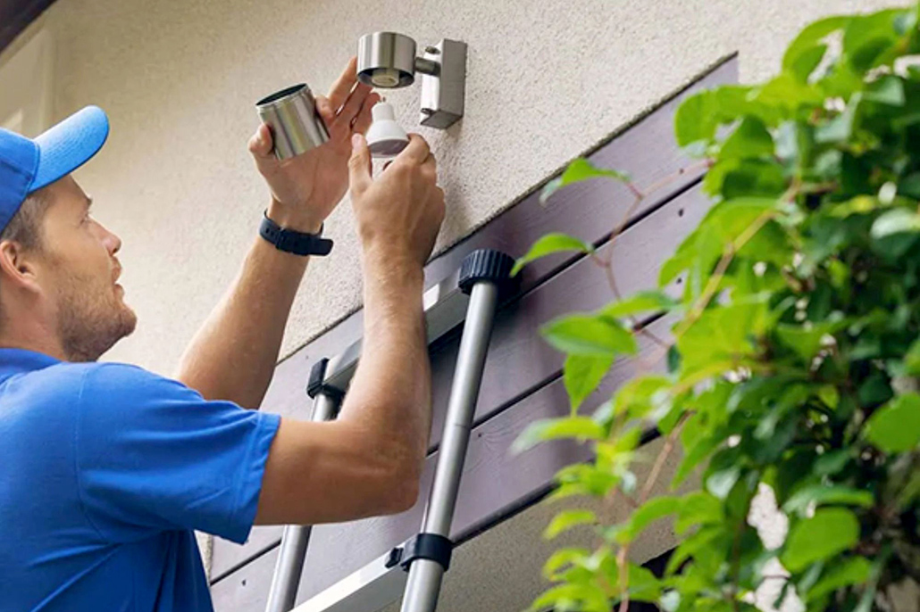 Contractor carrying out exterior building maintenance on a townhouse complex in Queensland