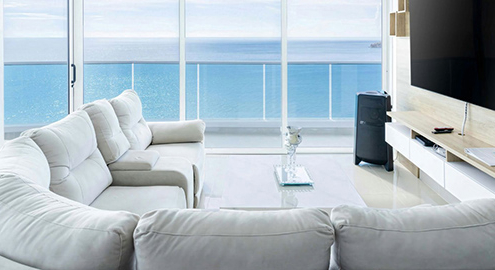 Coastal apartment living Australia with ocean view from modern living room.