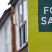 body-corporate-property-sale-sign For Sale sign outside a townhouse complex during a property inspection