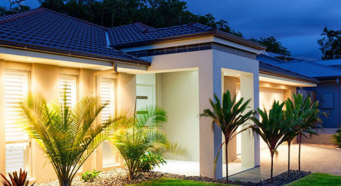Modern coastal townhouse complex representing lifestyle village vs body corporate living in Australia