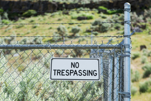 No trespassing sign on fencing beside land earmarked for future development
