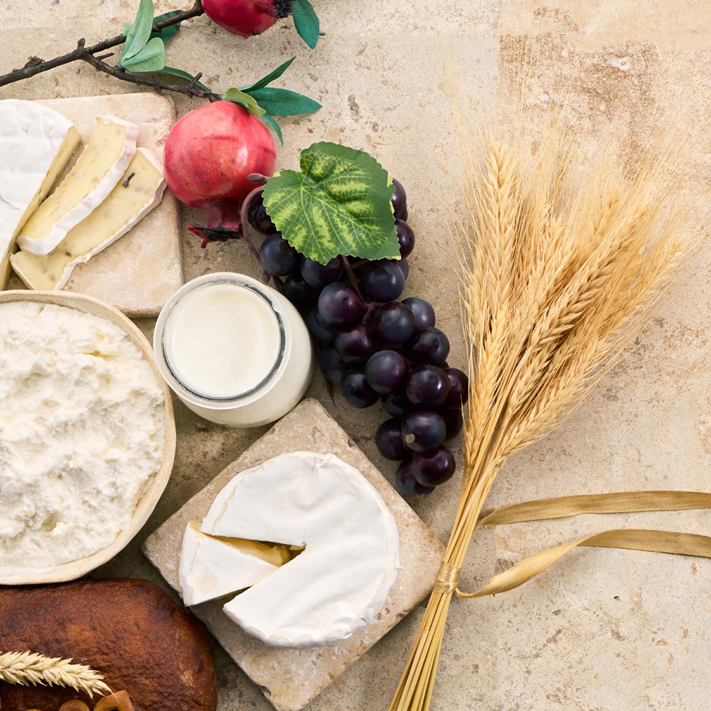 Cheese, grapes and grain representing food history and traditions