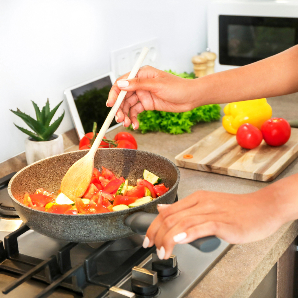 Eat & Sip: Cooking vegetables in a pan on a home kitchen stove
