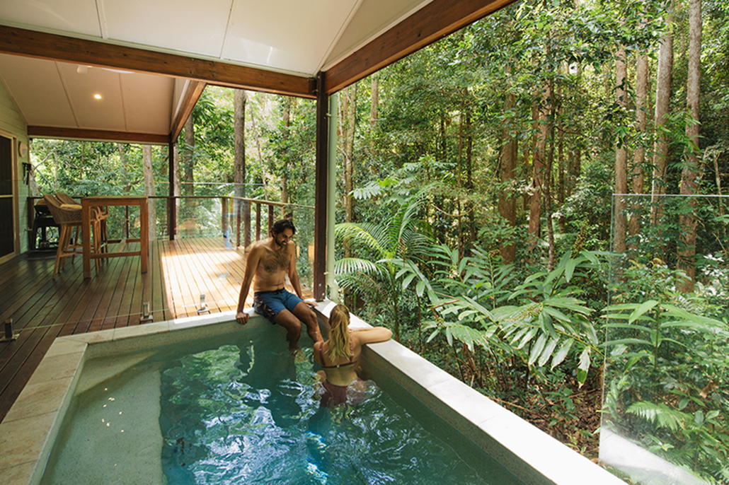 Couple relaxing in a plunge pool at Narrows Escape Rainforest Retreat in Montville