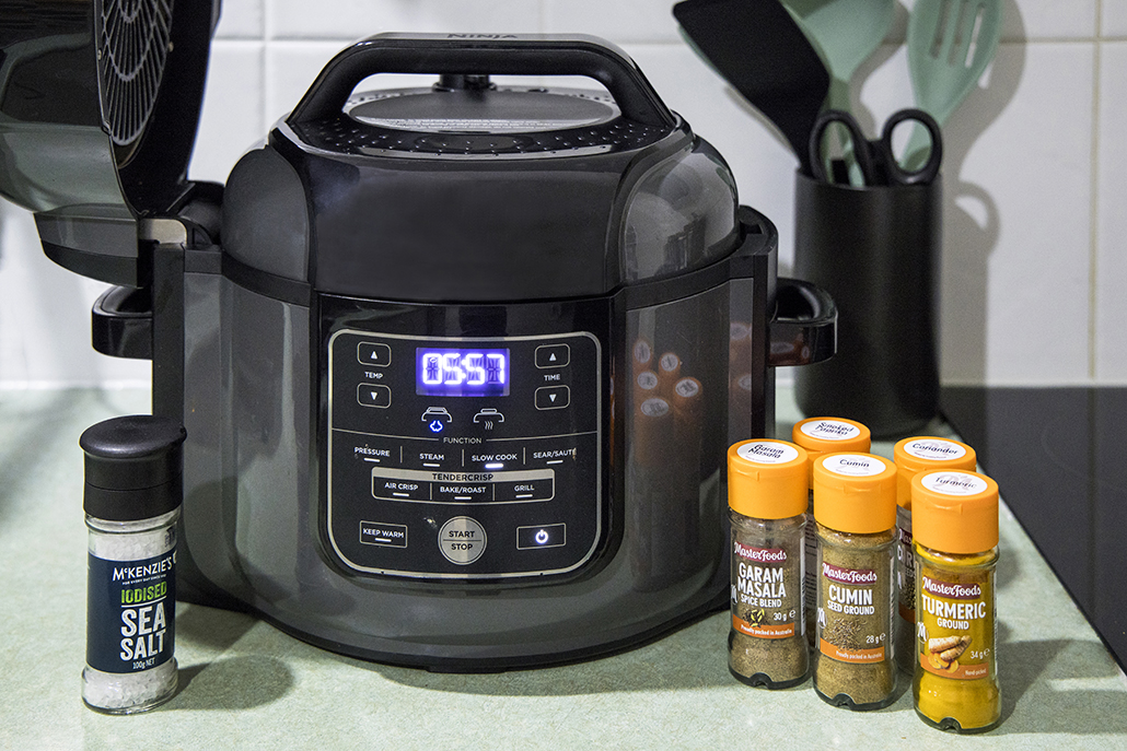 Ninja Foodi with spices ready for slow-cooked butter chicken recipe.