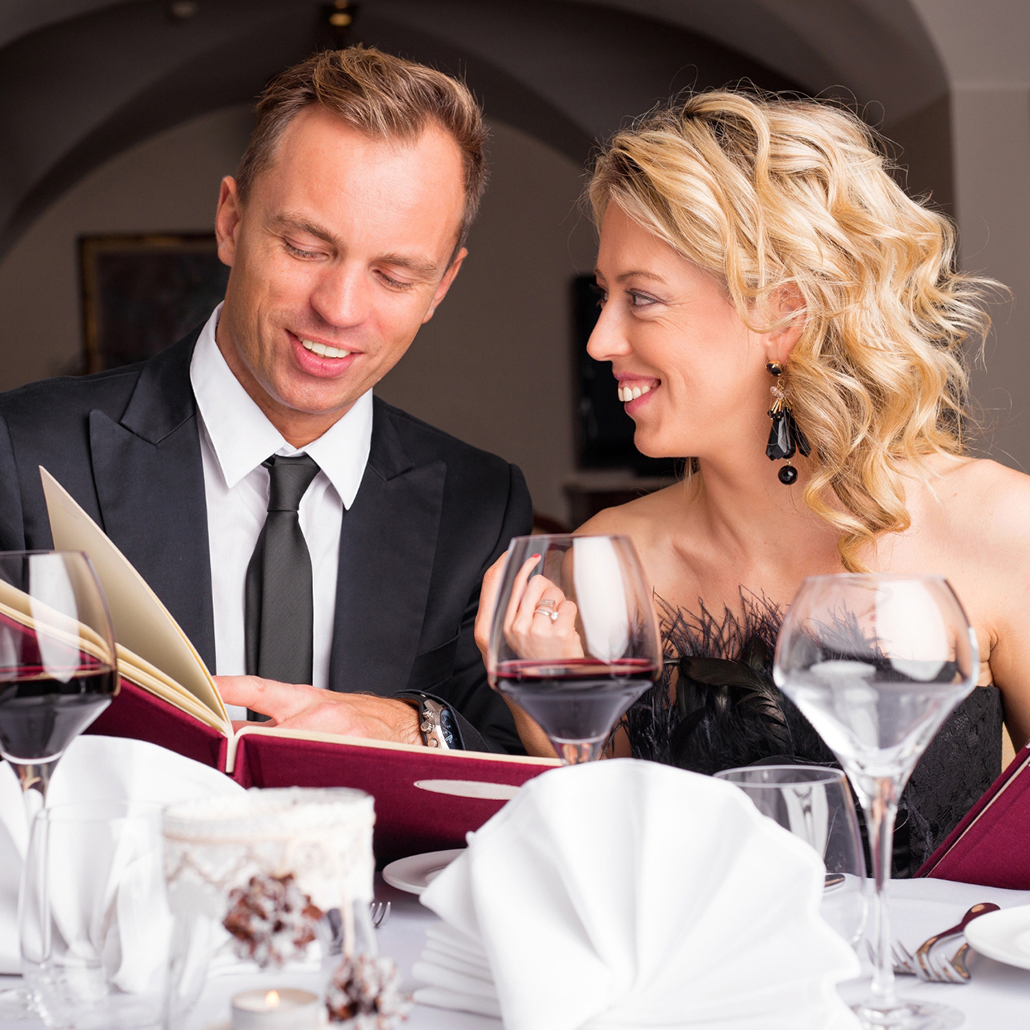 Eat & Sip: Couple dining out with wine and menu at a restaurant