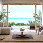 Light-filled coastal living room opening to tropical gardens and an ocean view