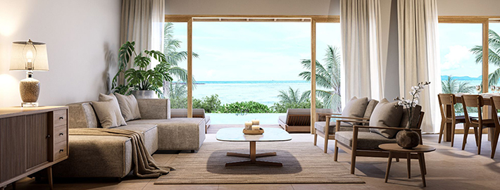 Light-filled coastal living room opening to tropical gardens and an ocean view