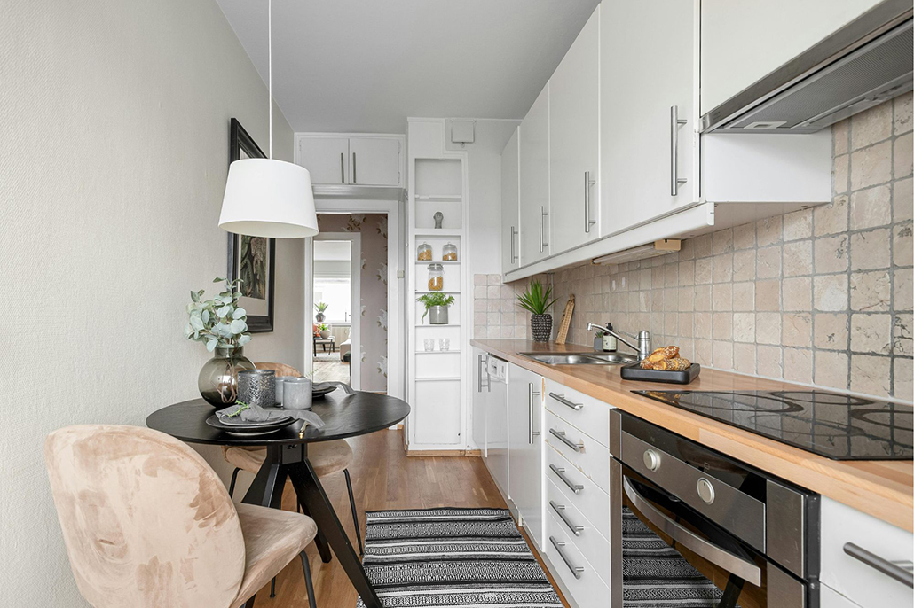 Compact kitchen with built-in storage and a small dining table